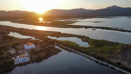 an aerial view of a house on an island in the water at Tenuta Feraxi - Private Paradise in San Priamo