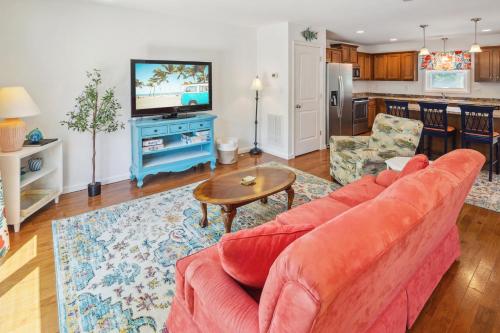 a living room with a couch and a tv at 5517 - Harbour Haven in Kill Devil Hills