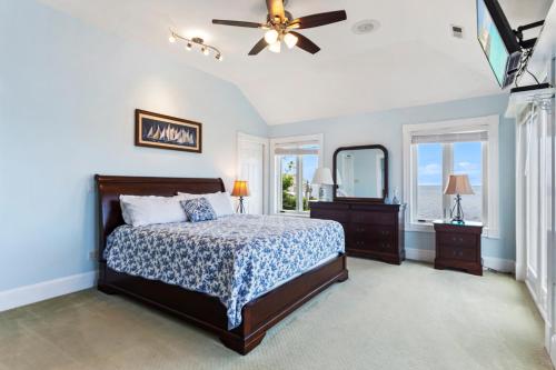 a bedroom with a bed and a ceiling fan at 5550 - Lighthouse Pointe in Kill Devil Hills