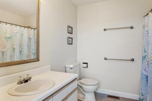 a white bathroom with a sink and a toilet at 5550 - Lighthouse Pointe in Kill Devil Hills