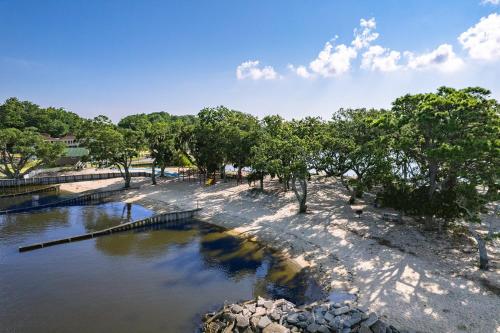 a body of water with trees on the shore at 5550 - Lighthouse Pointe in Kill Devil Hills