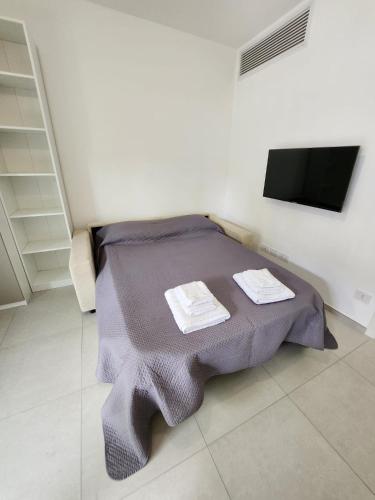 a bedroom with a bed with two towels on it at TODE's Apartment in San Benedetto del Tronto