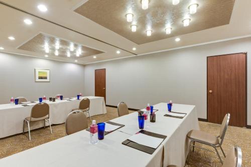 a conference room with white tables and chairs at ANA Crowne Plaza Hiroshima by IHG in Hiroshima