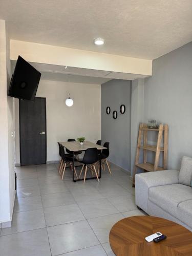 a living room with a table and a couch at Casa del Lago in Veracruz