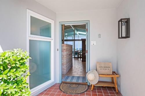 a hallway with a door leading to a patio at Surfers Paradise in Santa Barbara