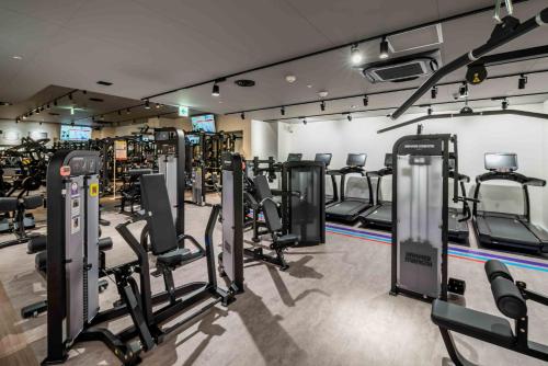 a gym with a bunch of treadmills and machines at ANA Crowne Plaza Hiroshima by IHG in Hiroshima