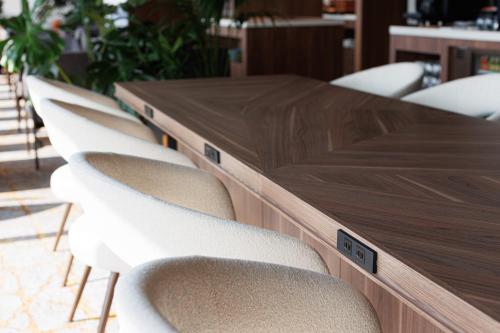 a wooden conference table with white chairs around it at ANA Crowne Plaza Hiroshima by IHG in Hiroshima