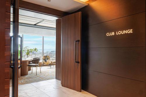 a door to a lobby with a dining room at ANA Crowne Plaza Hiroshima by IHG in Hiroshima