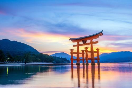 a torii gate in the middle of a body of water at ANA Crowne Plaza Hiroshima by IHG in Hiroshima