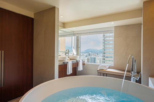 a bathroom with a tub and a view of a city at ANA Crowne Plaza Hiroshima by IHG in Hiroshima