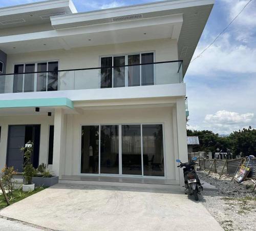 a motorcycle parked in front of a house at Oia in Moalboal