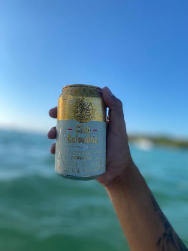 a person holding up a can of beer at Brisas del Mar vista al Mar in Playa Blanca