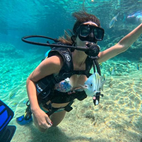 a woman in the water with a scuba diver at Brisas del Mar vista al Mar in Playa Blanca
