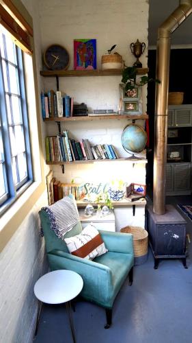 a living room with a couch and a table at The Art Room in Somerset West