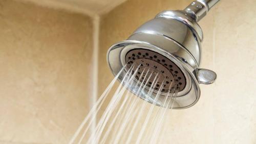 a blow dryer hanging from a shower head at Holiday Inn Orizaba by IHG in Orizaba