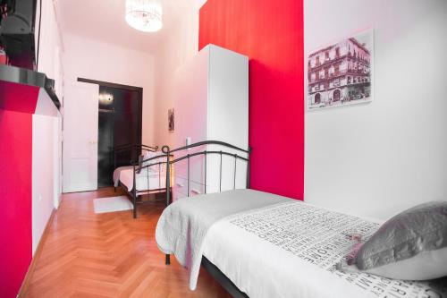 a bedroom with red and white walls and a bed at VisitZagreb Ruby in Zagreb