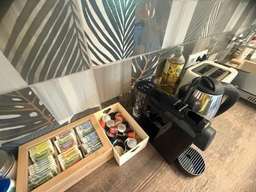 a coffee maker on a counter next to a box of food at Offline Vendégház in Orfű