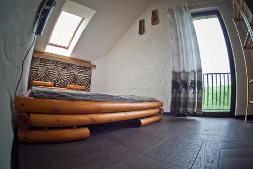 a bedroom with a bed made out of logs at Dom na mazurach, sauna, jacuzzi, jezioro Garbas, łódka, 5 sypialni in Liski