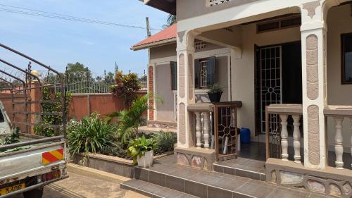 a house with a truck parked in front of it at J and A Villas Homestay in Mbale