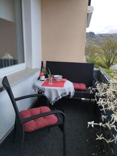 a table and two chairs sitting on a balcony at Ferienwohnung Moselherz in Reil