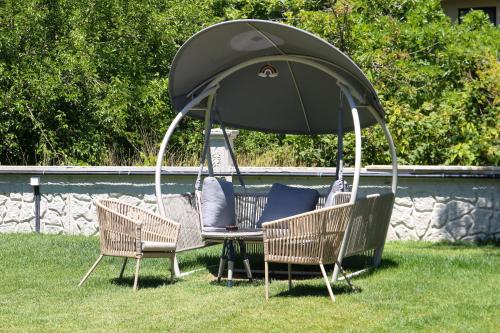 a gazebo with chairs and a table in the grass at Mints Hotel Ağva in Agva