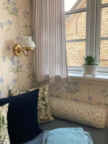 a room with a window and a couch with a pillow at Staevnegaarden in Flødstrup
