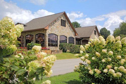 a large house with a yard with flowering bushes at The Dillard House in Dillard