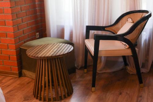 a chair and a stool next to a brick wall at Mints Hotel Ağva in Agva
