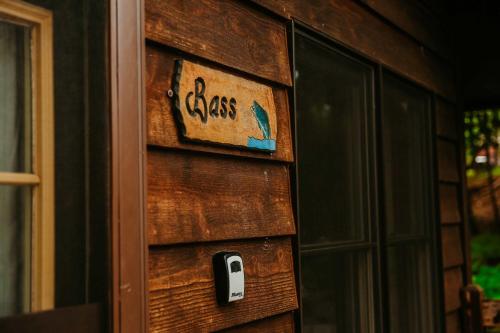 a door with a glass sign on the side of a house at Old Stoney's Bass - Big Arbor Vitae Lake in Arbor Vitae