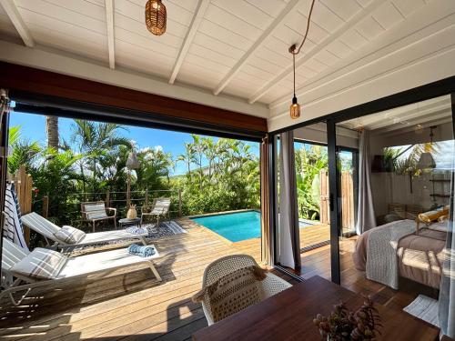 a living room with a view of a pool at ZANNANNA LODGE in Le Diamant