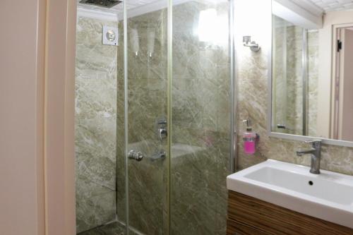 a bathroom with a shower and a sink at Mints Hotel Ağva in Agva