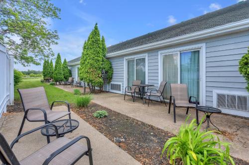 a patio with chairs and tables in front of a house at Indiana Beach Hotel in Monticello