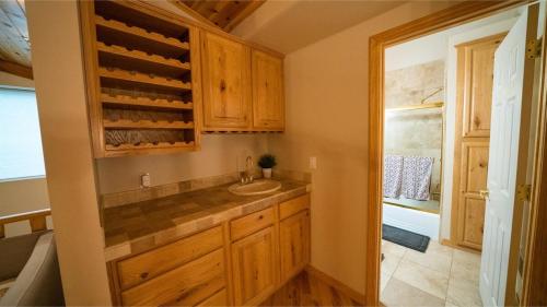 a kitchen with wooden cabinets and a sink and a window at Summer Special-Pinetop Cabin-Great 4 Family in Pinetop-Lakeside