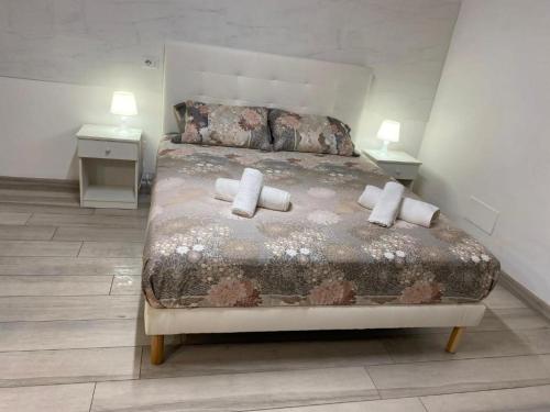 a bedroom with a bed with two pillows on it at Vendicari in Pachino