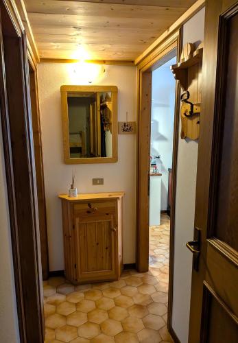 a bathroom with a sink and a mirror on the wall at Ciasa Nuvola Apartment in Cibiana