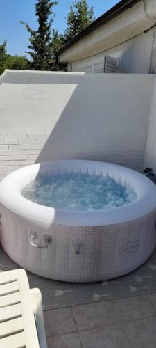 a large bath tub with blue water in it at Apartment Rupena in Klimno