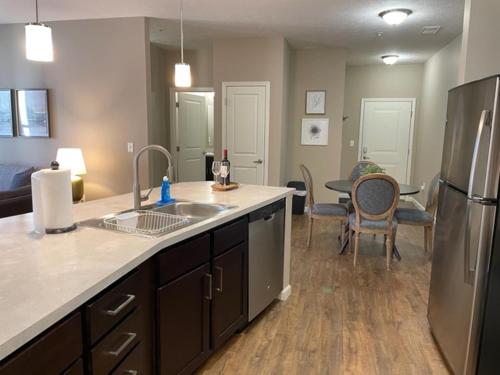 a kitchen with a sink and a refrigerator and a table at The Hilliard Executive No Steps Amazing Beds! in Dublin