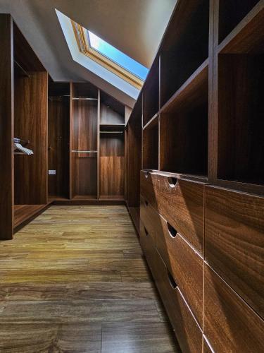 a room with wooden cabinets and a skylight at Beachside - Stunning sea view townhouse across the road from the beach in Kilkeel