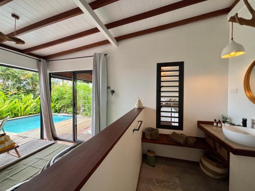 a bathroom with a sink and a tub at ZANNANNA LODGE in Le Diamant