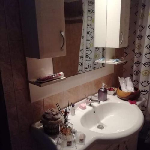 a bathroom with a sink and a mirror at Beautiful stone house in Samos in Samos
