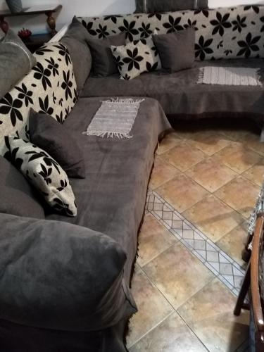 a couch with pillows on it in a living room at Beautiful stone house in Samos in Samos