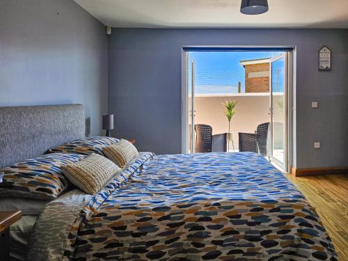 a bedroom with a bed with a view of the ocean at Beachside - Stunning sea view townhouse across the road from the beach in Kilkeel