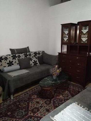 a living room with a couch and a dresser at Beautiful stone house in Samos in Samos