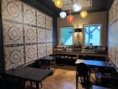 a restaurant with tables and a counter in a room at Złota Regalinda & Spa in Międzyzdroje