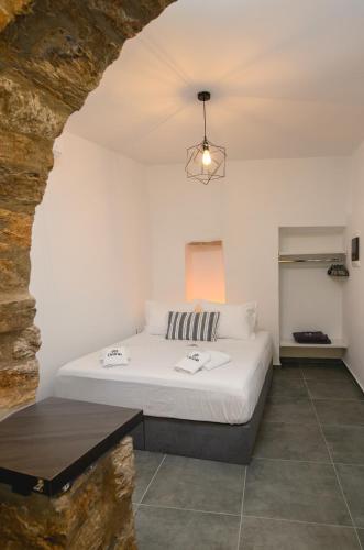 a bedroom with a white bed in a room at Omnia Apartments Amorgos Studio in Amorgos