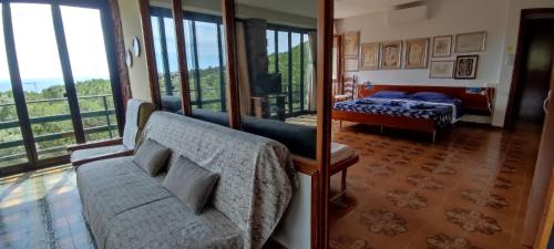 a living room with a couch and a bed at La bouganville Apartments in Cala Gonone