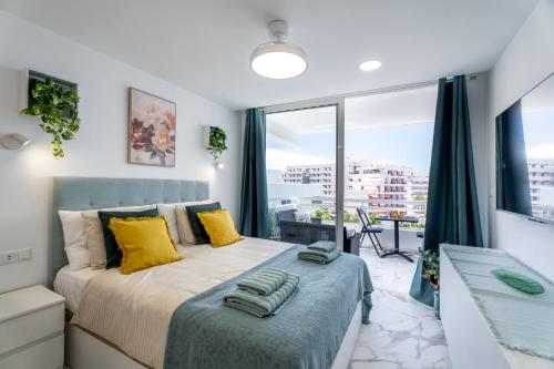 a bedroom with a bed and a large window at Costa Serena Apartment 420 in Costa de Adeje