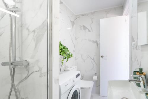 a bathroom with a shower and a toilet and a sink at Costa Serena Apartment 420 in Costa de Adeje