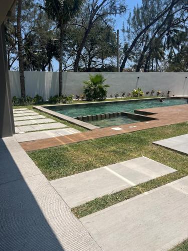 a swimming pool in the middle of a yard at Family Vacations Incredible Beach and Pool in Boca del Río