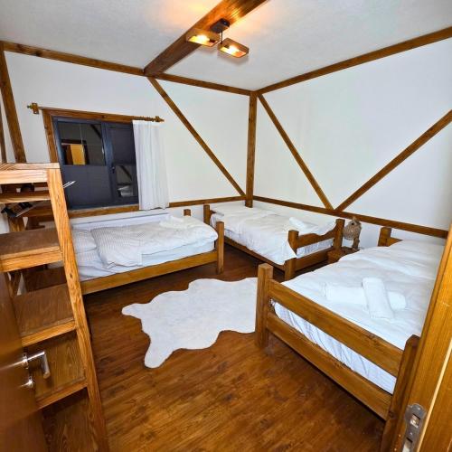 a room with two beds and a tv in a room at Uludag Zirve Garden - BBQ Jacuzzi 